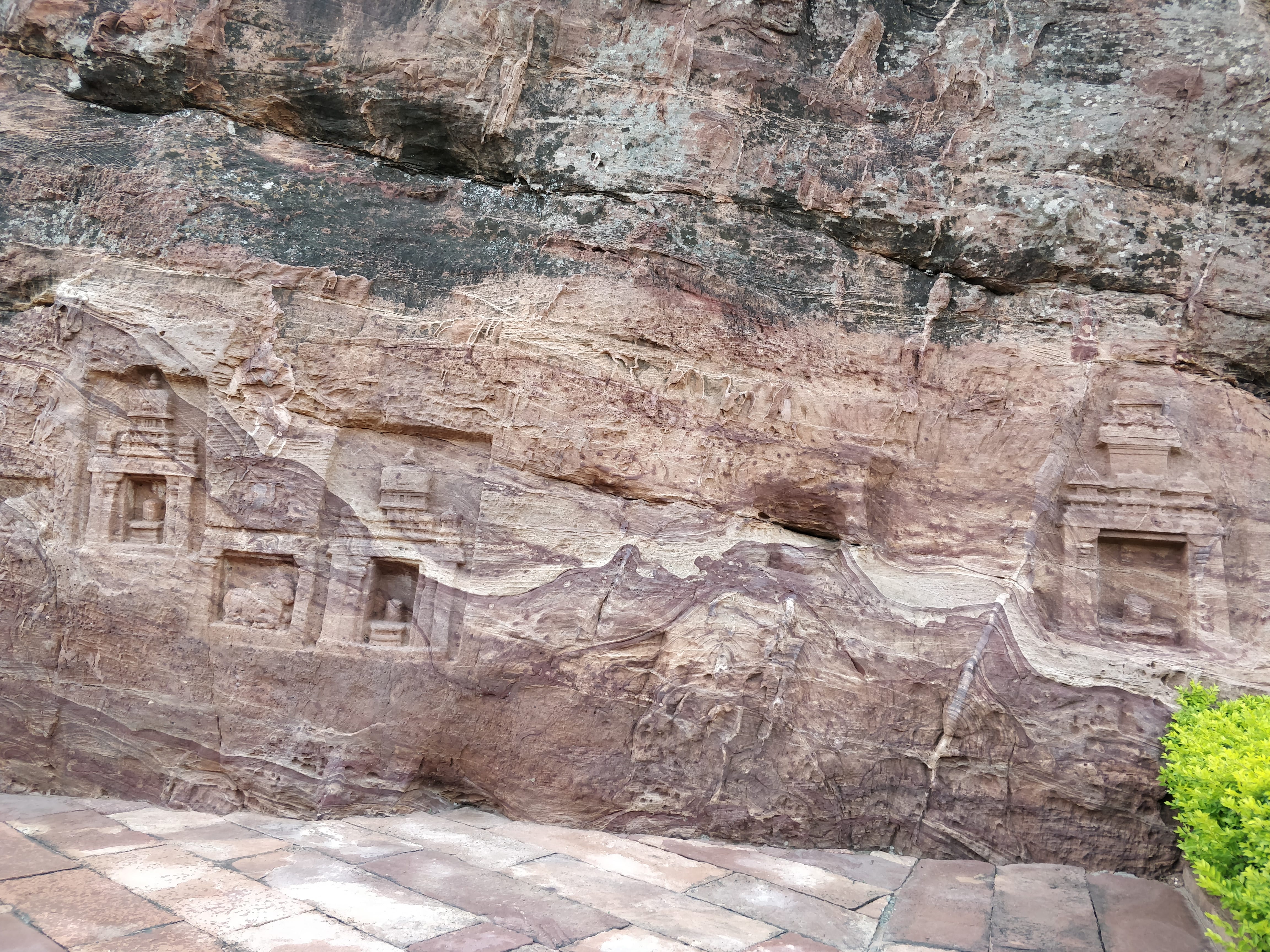 carvings on colourful layered rock