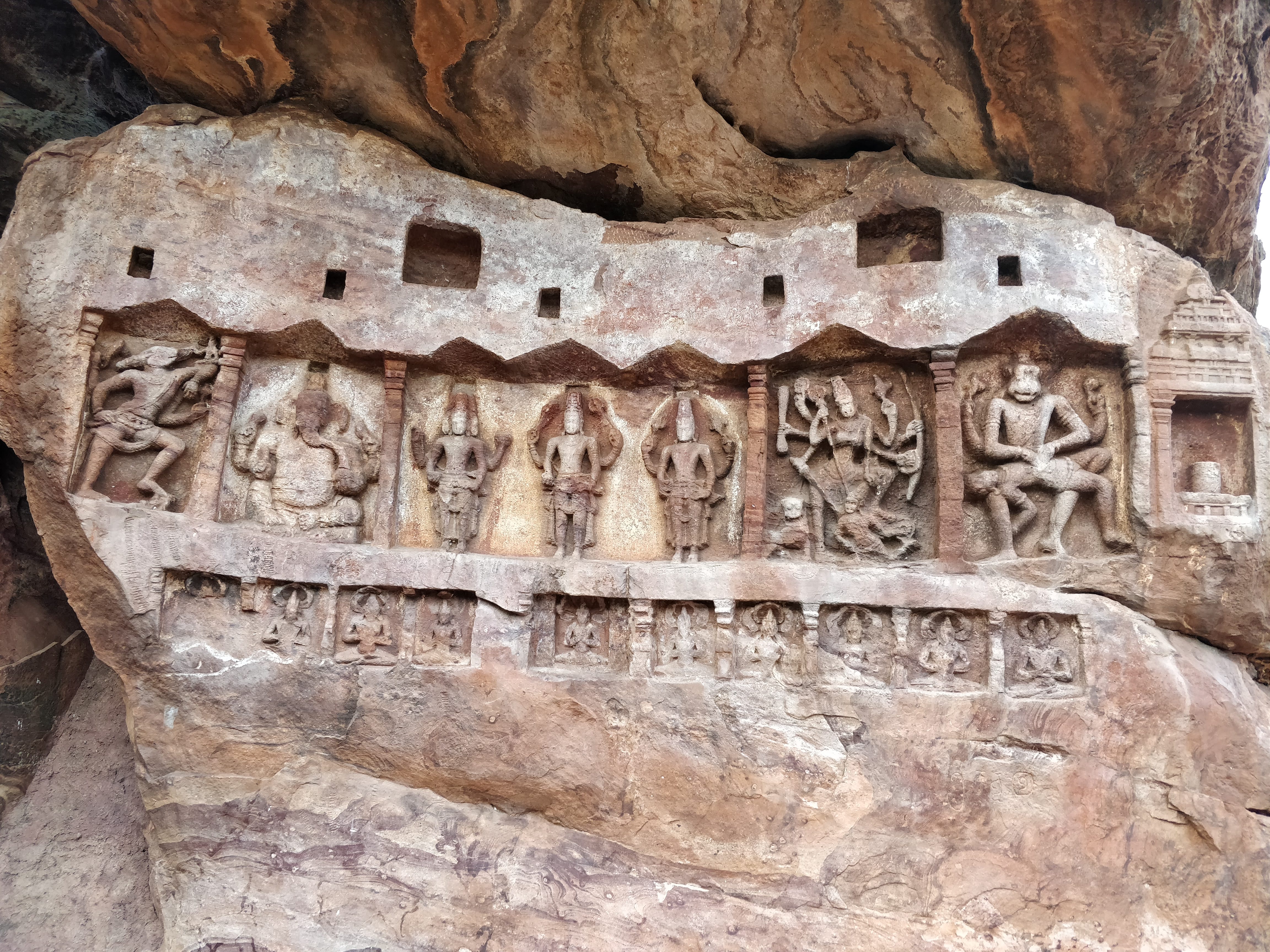 carvings on colourful layered rock